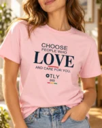 Close-up of the cotton pink Choose Love T-shirt showing the “Choose people who love and care for you” slogan and OTLY 869 branding.